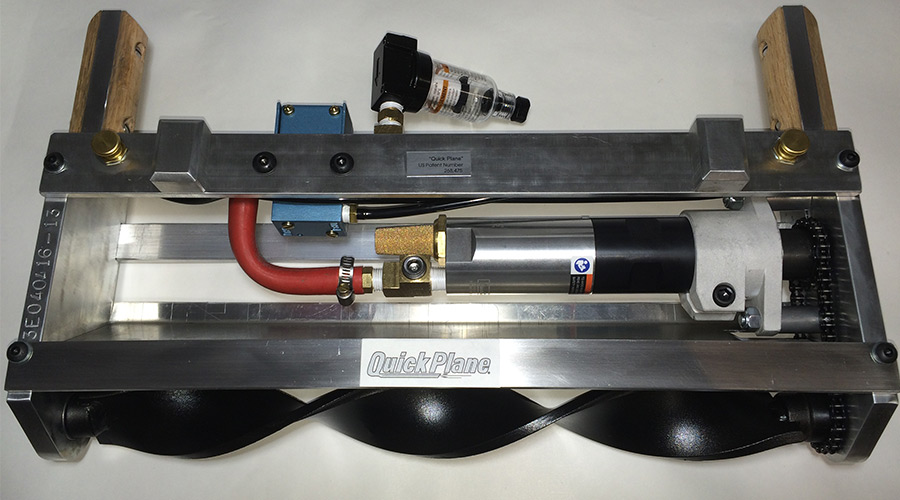 The QuickPlane foam insulation trimmer — aluminum frame, pneumatic motor, and spiral cutting blade
